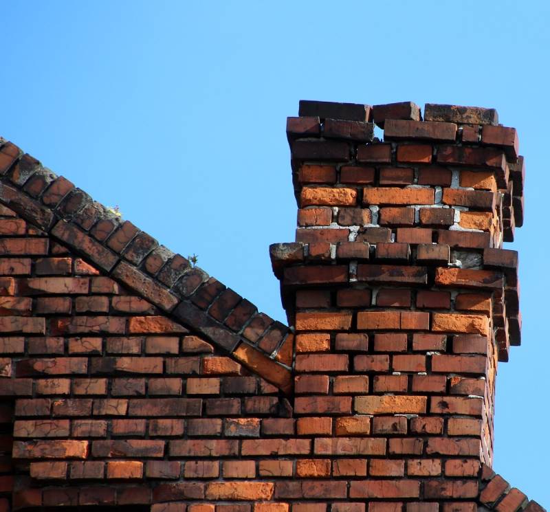 Damaged chimney on an Haverhill home showing cracks and missing mortar